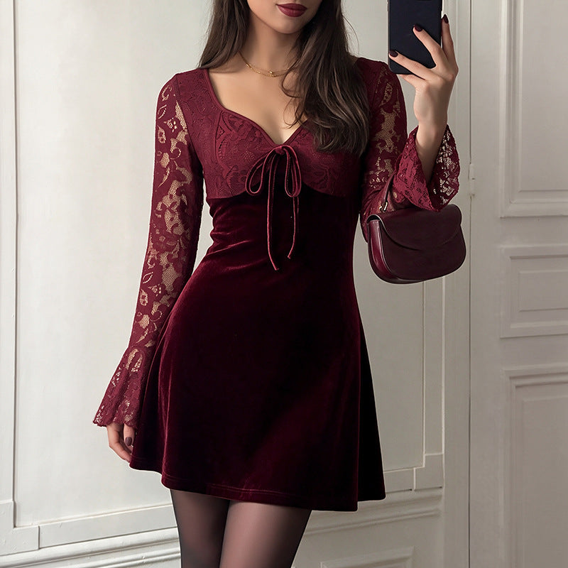 Burgundy velvet mini dress with lace sleeves and tied neckline bow, side view