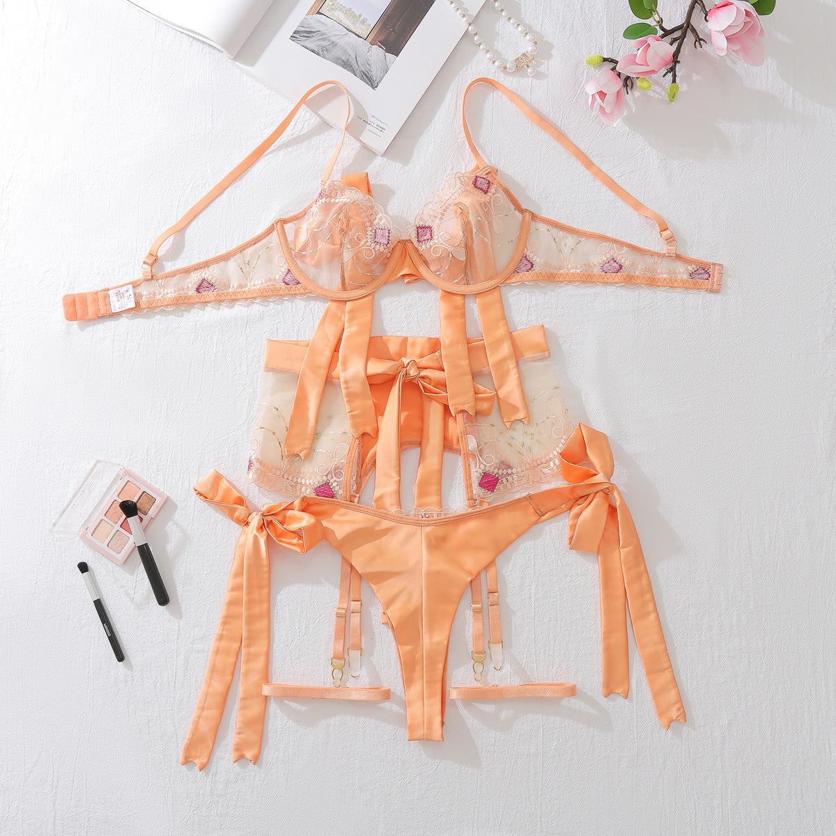 Embroidered mesh lingerie set in champagne with sheer panels, ribbon bows, lace edging and garters