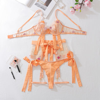 Embroidered mesh lingerie set in champagne with sheer panels, ribbon bows, lace edging and garters