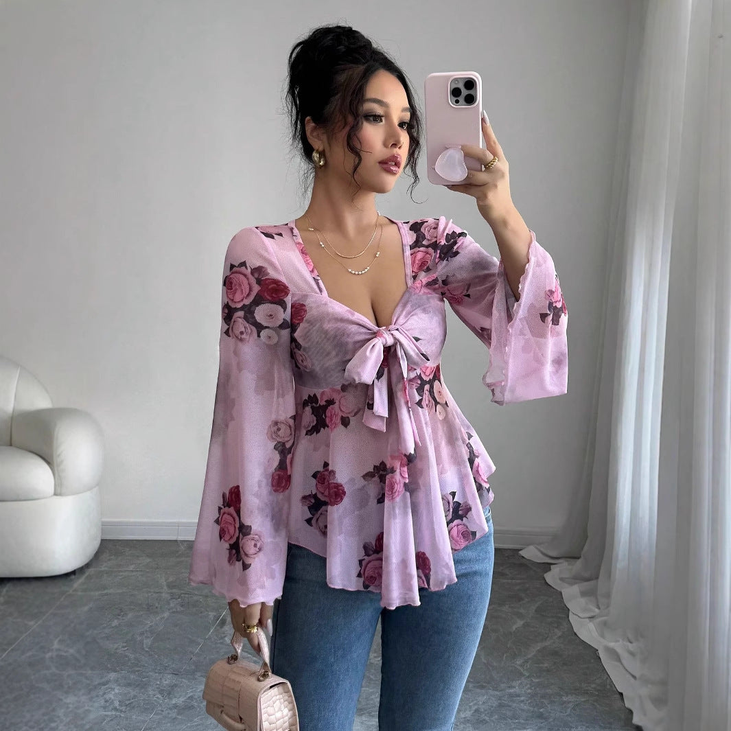 Floral bow-front blouse in light purple with long bell sleeves and flared hem