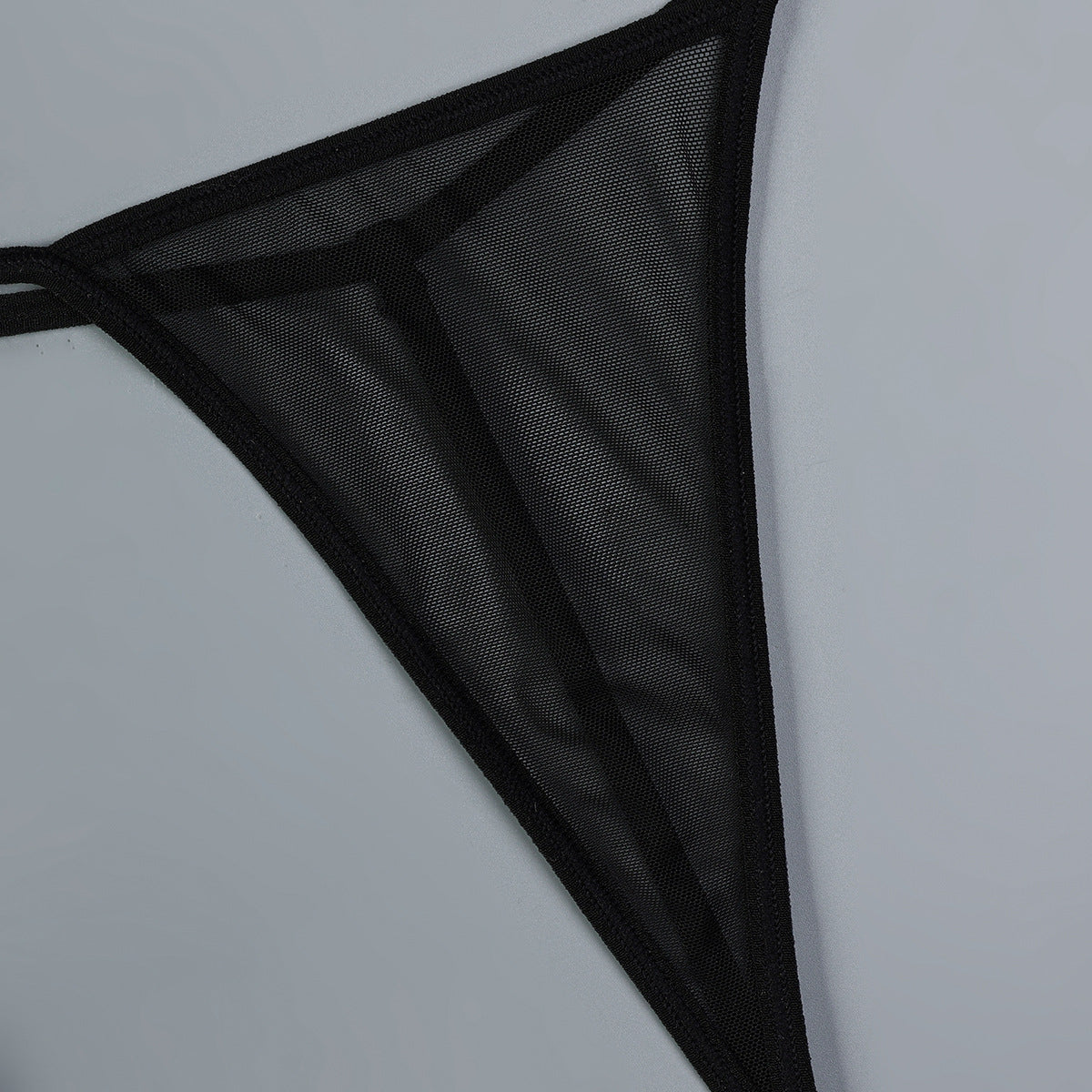 Black sheer mesh fabric edge with fine dot texture and bold contrast trim