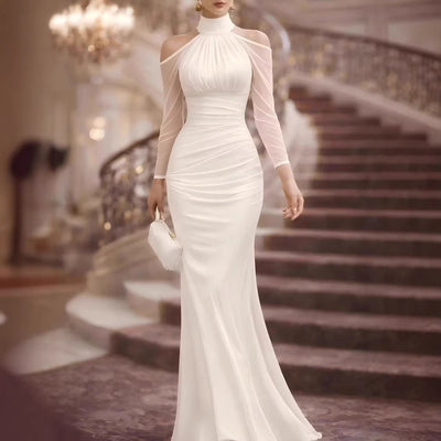 White sheer long-sleeve evening gown with high neck, draped bodice and mermaid hem