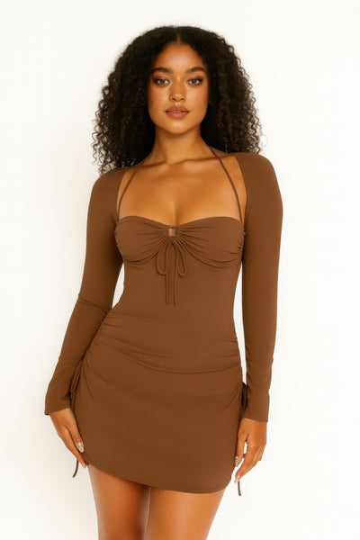Woman wearing a brown long-sleeve dress with a fitted silhouette on a white background