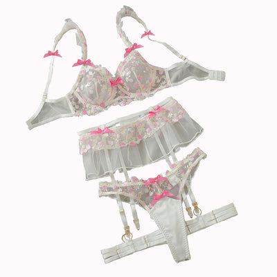 Floral embroidered lingerie set with ruffled mesh bra, garter straps, and matching panties.