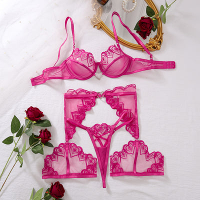Rose red sheer mesh lingerie set with embroidered bra and thong, flat lay