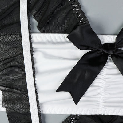 Black lingerie maid dress with satin bow and white ruffled trim.