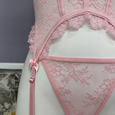 Pink lace bustier set with scalloped cups and garter straps, bow front detail