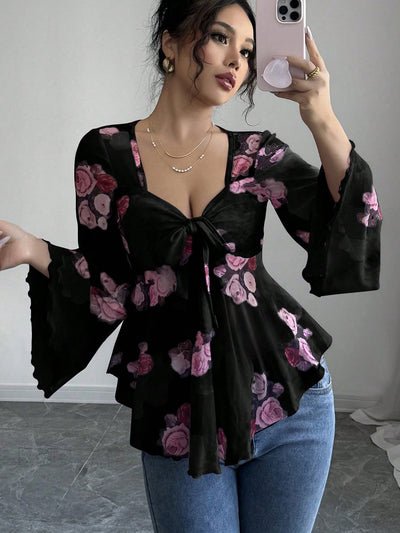 Floral bow-front blouse in black with long bell sleeves and flared hem