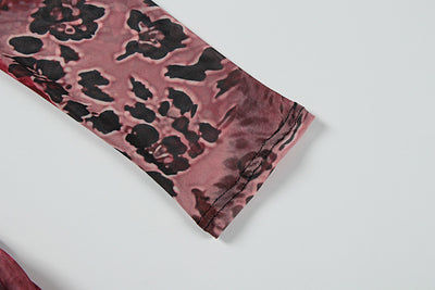 Close-up of mixed print mesh fabric corner in dark rose, black, and burgundy