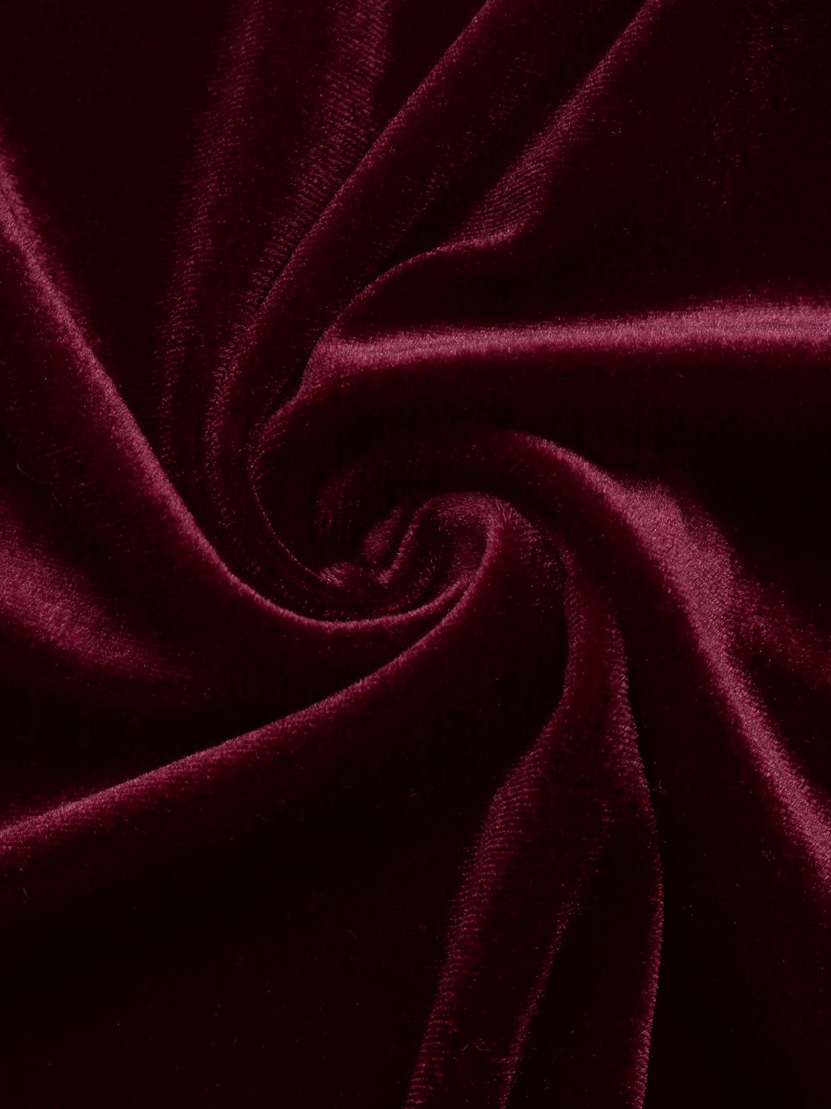 Close-up of burgundy velvet fabric with soft sheen texture
