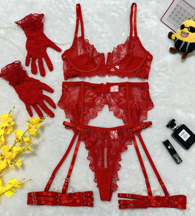 Red lace lingerie set flat lay with bra, garter belt, high-waist bottoms, and cuffs