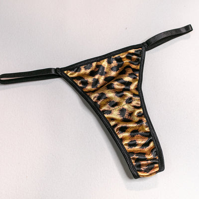 Leopard-print lace thong with black scalloped edges and thin adjustable side ties