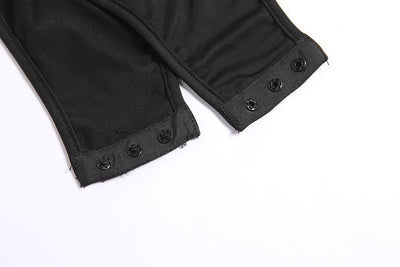 Close-up of black fabric garment legs with snap-button cuffs on a white background.