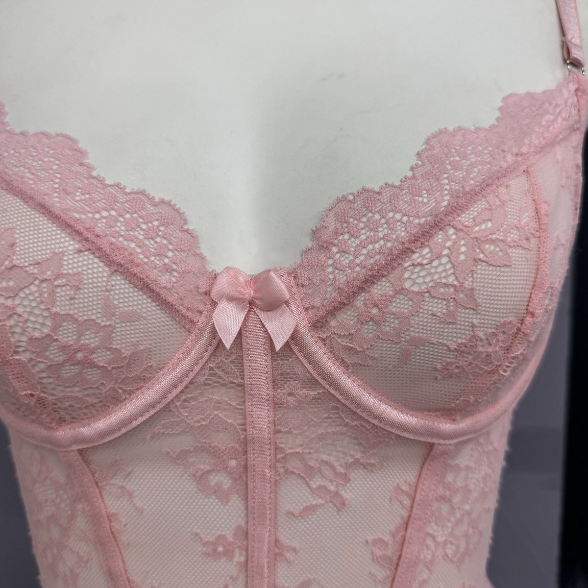 Pink lace bustier with scalloped cups and center bow, adjustable garter strap