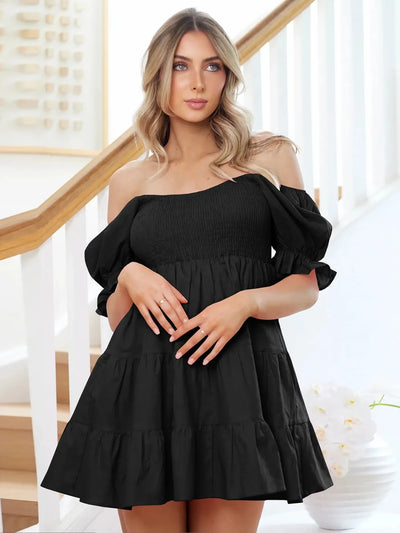 Black smocked tiered mini dress with off-shoulder neckline and puff sleeves