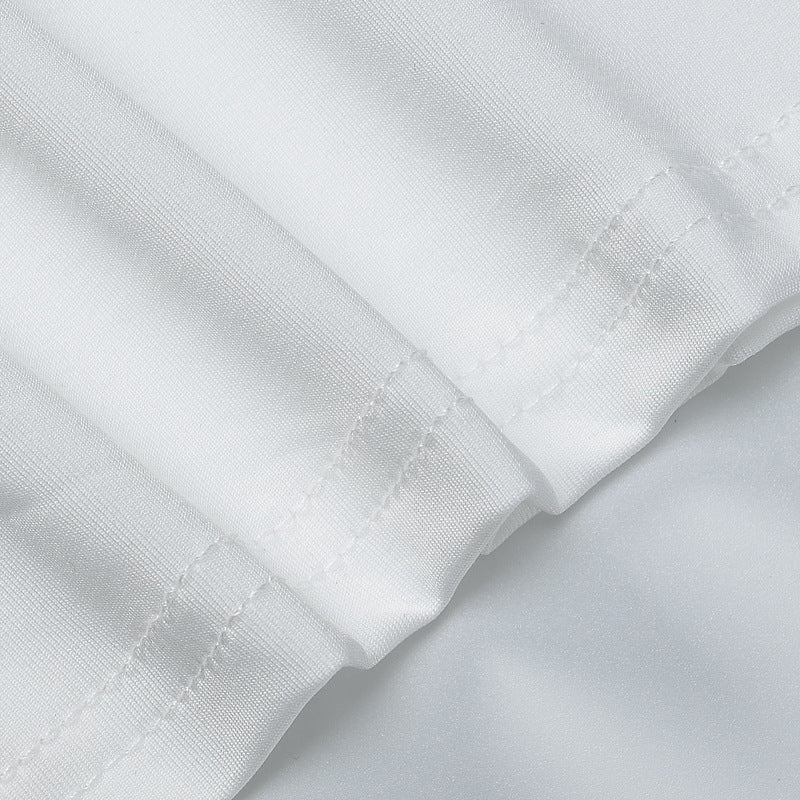 White long-sleeve cuff and seam finish close-up on maxi dress fabric
