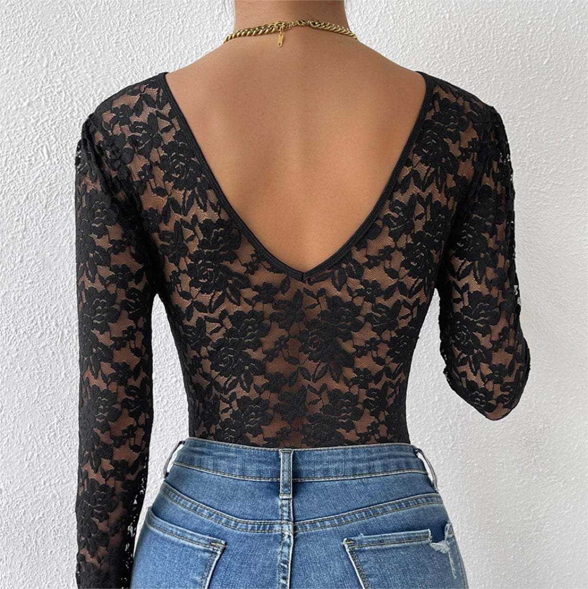 Black lace long-sleeve bodysuit with low V-back and sheer lace sleeves