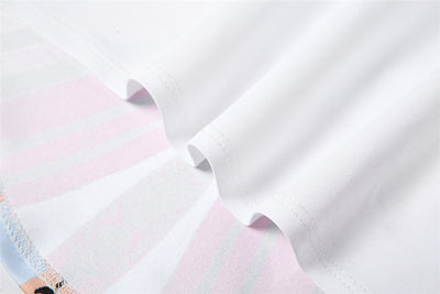 Close-up of white fabric with multicolor butterfly print trim on crop top