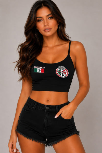 Woman wearing a black tank top with 'Mexico' and a flag design, paired with black shorts on a gray background.