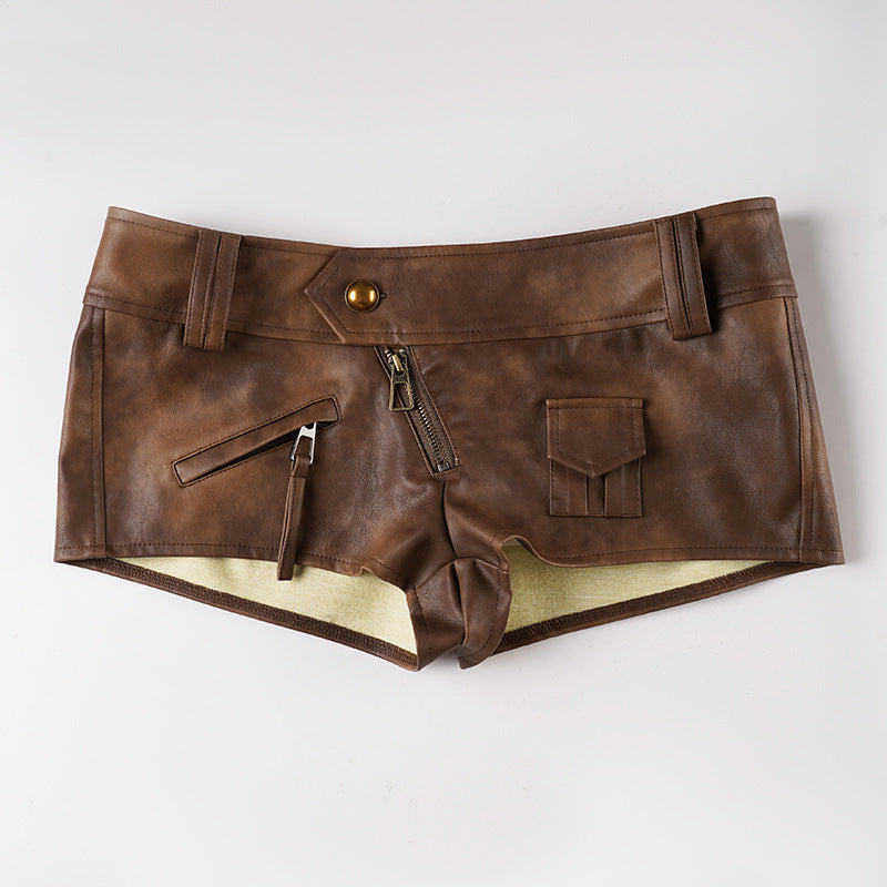 Brown leather-look low-rise shorts with zip fly and front pockets, belt loops.