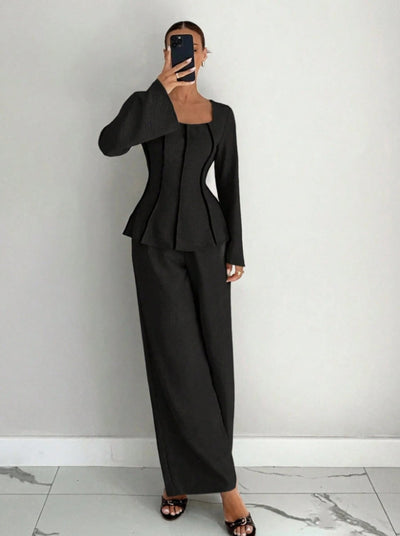 Black wide-leg pants set with structured peplum-style top and flared sleeves