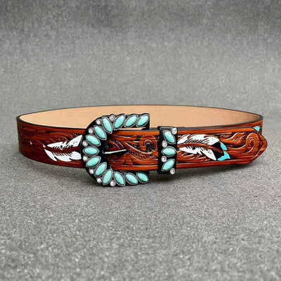 Western feather belt flat lay: brown tooled leather with turquoise stone oval border and buckle