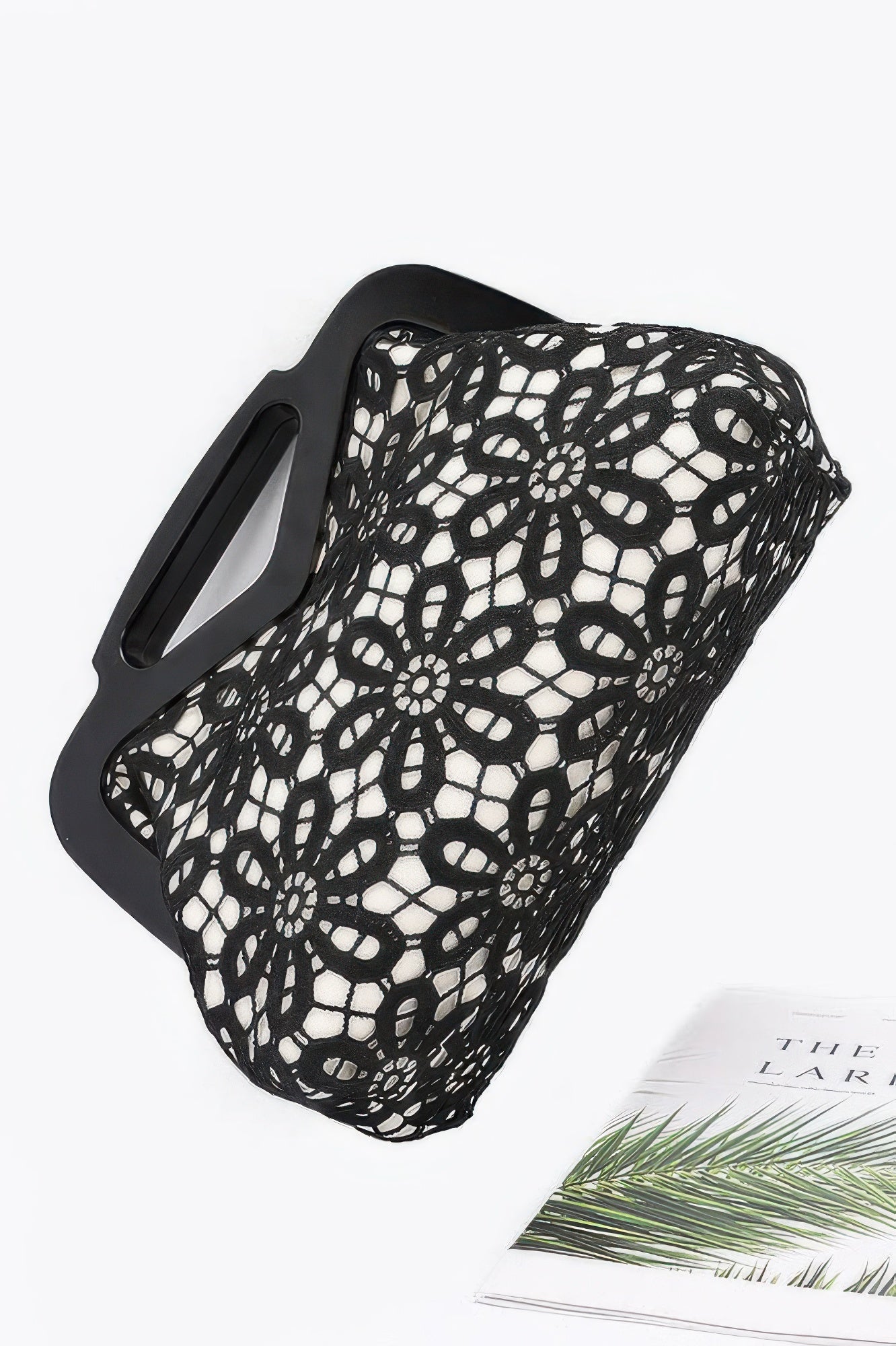 Black floral crochet wood frame clutch with white lining and cutout rectangular wooden handles