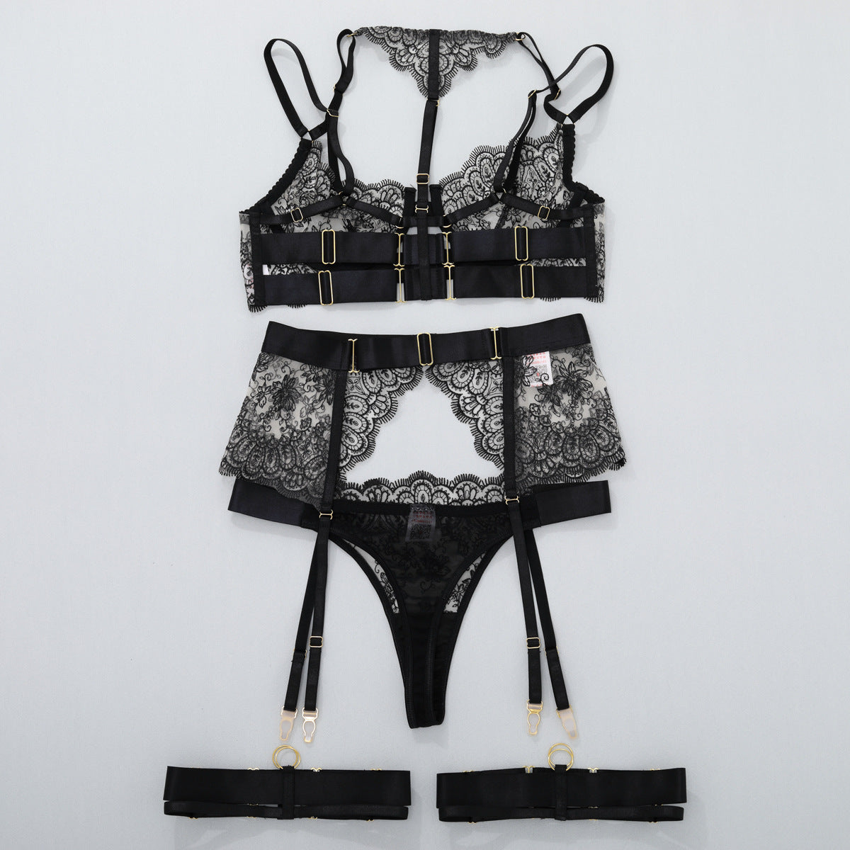Black lace lingerie set with garter belt and thigh straps, matching thong