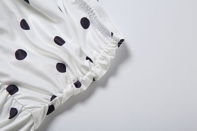 White polka-dot off-shoulder top with ruffled sleeve and gathered hem