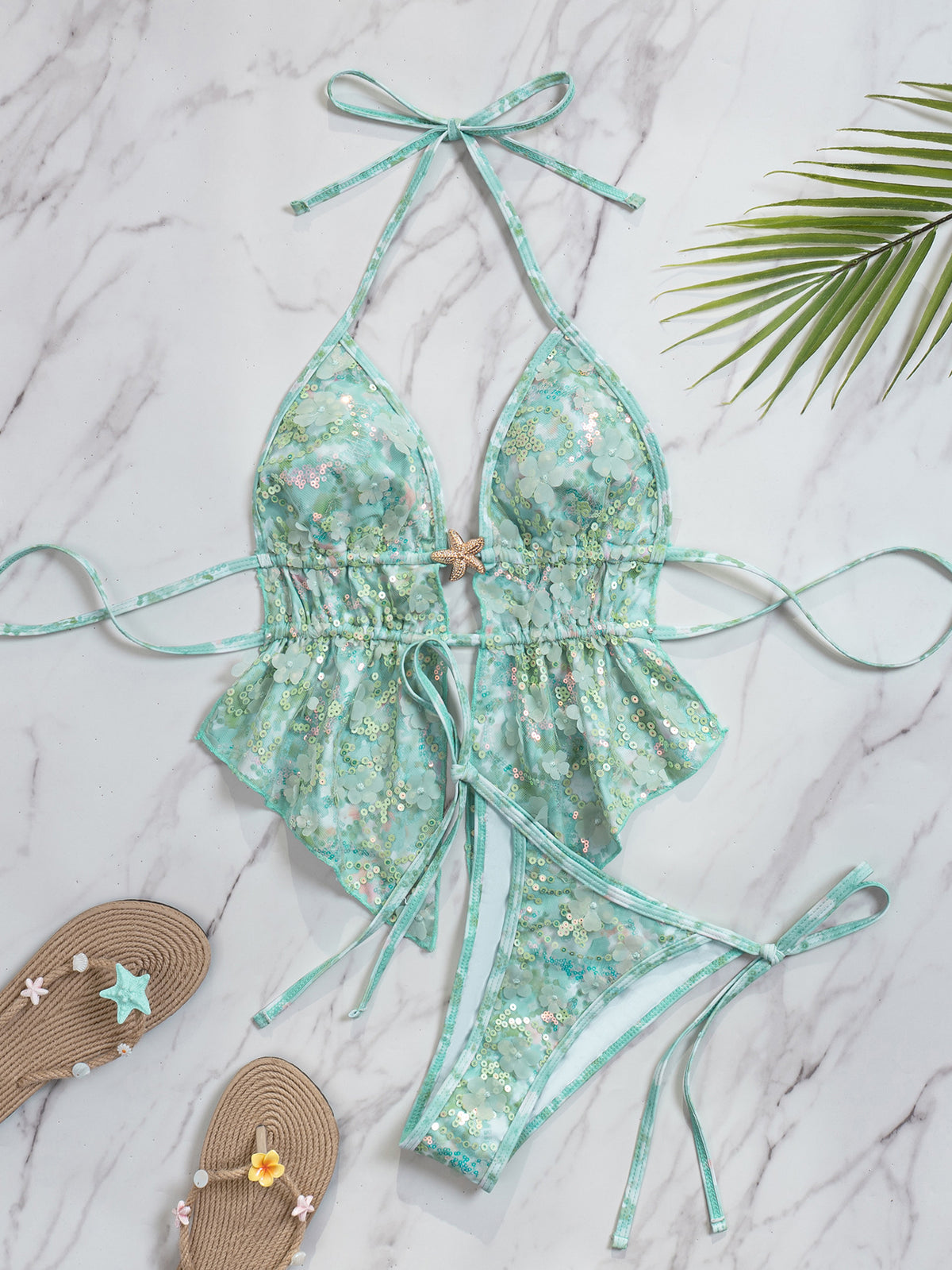 Aqua floral halter bikini set with peplum top and tie-side bottoms, shown with sandals