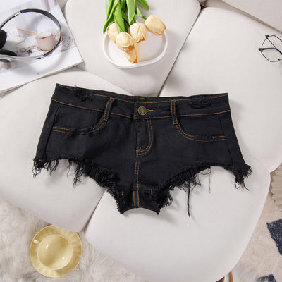Black denim low-rise shorts with frayed hem and front flap-style pockets