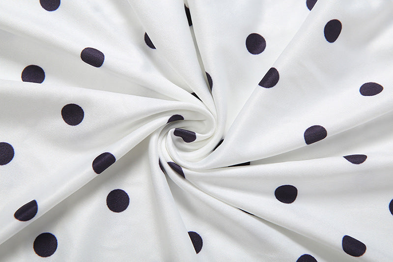 White polka-dot fabric with soft drape and gathered texture