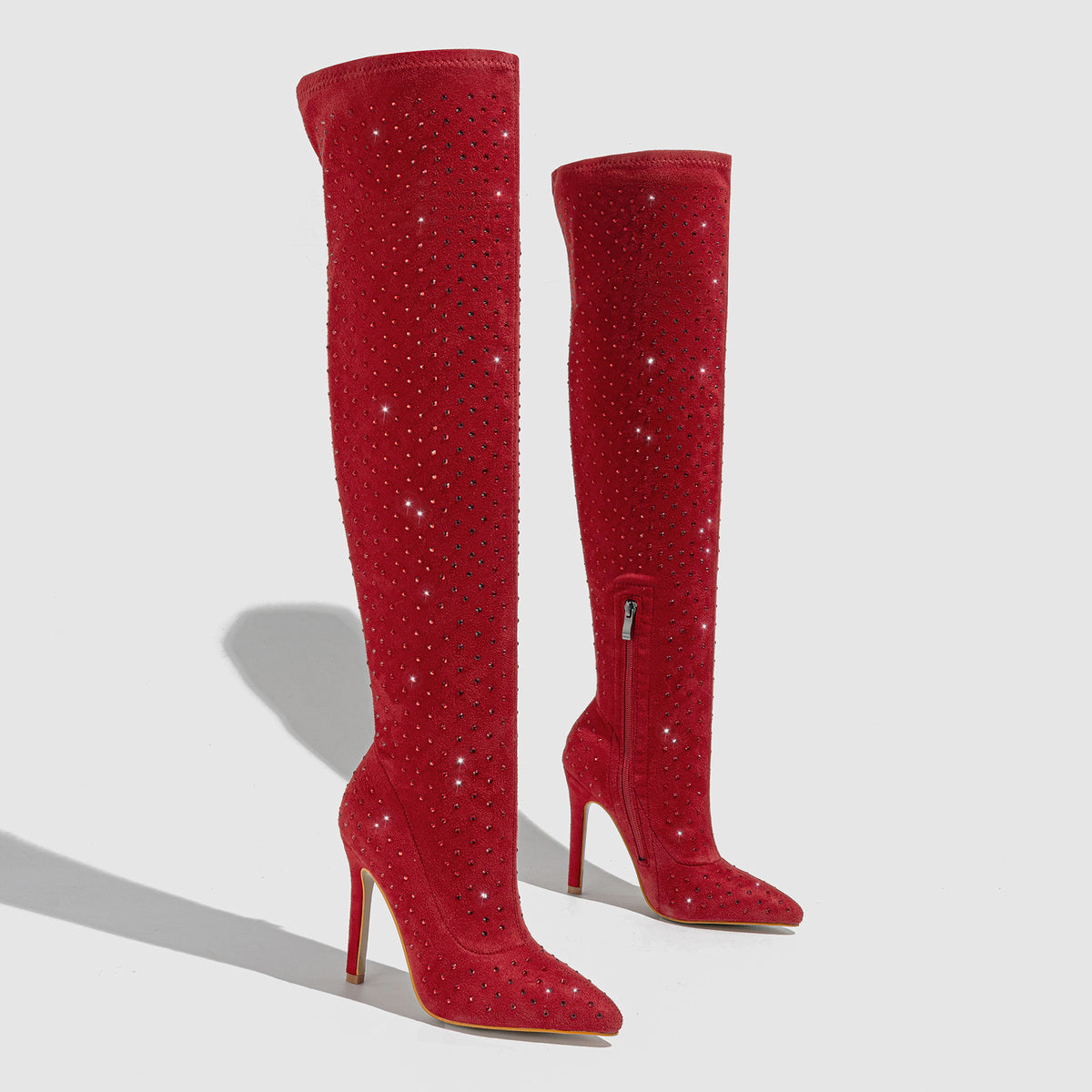 Red over-the-knee stiletto boots with sparkly detail and side zipper