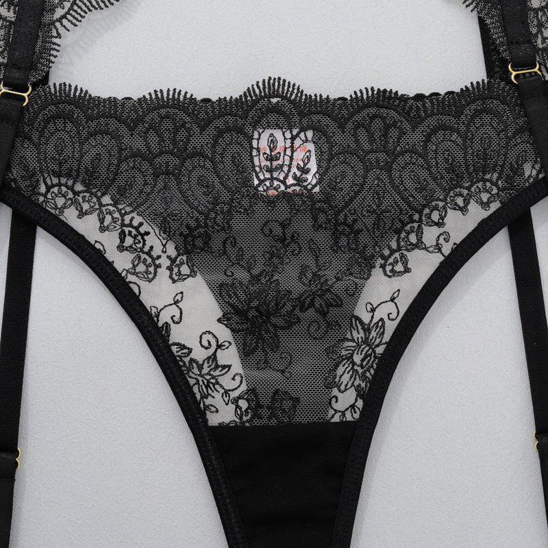Black lace thong underwear with decorative mesh panel and garter belt straps