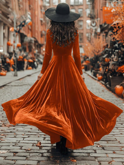 Orange velvet maxi dress with long sleeves and wide flared skirt