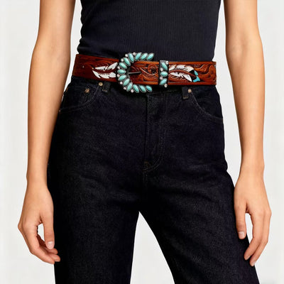 Western feather belt on dark jeans: turquoise stone inlay and engraved buckle with feather design