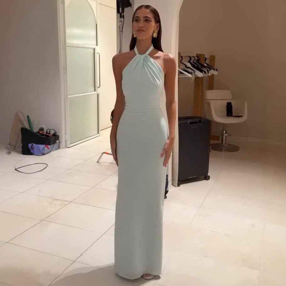 Model wearing an Elegant Formal Gown in light mint green showcasing a halter neckline