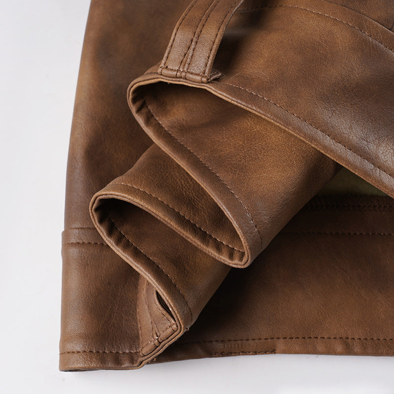 Cuffed inner lining and stitching detail on brown leather-look shorts.