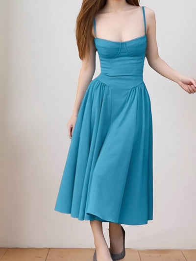Blue dress worn by a person on a plain background
