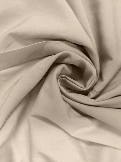 Close-up of beige fabric with folds