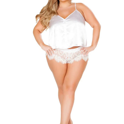 A plus-size model wearing a white satin camisole top and matching white lace panties against a plain white background.