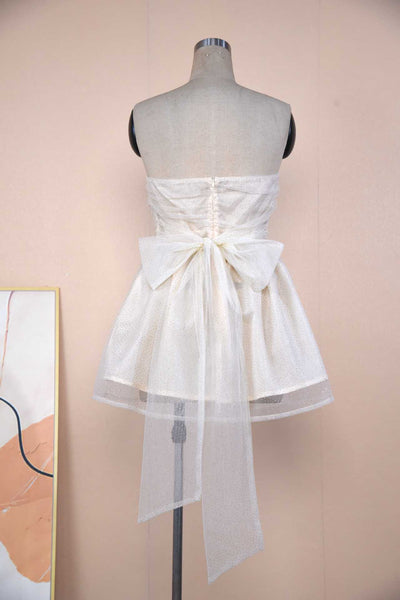Back view of a Sparkle Strapless Mini Dress featuring a bow detail and delicate fabric