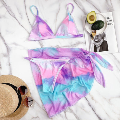 Trendsi Triangle Micro Bikini in pastel tie-dye colors with matching sarong on marble surface